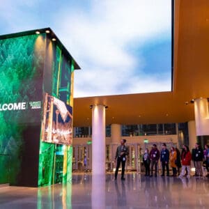 Welcome sign at the Climate Pledge Arena with people in a group beneath it