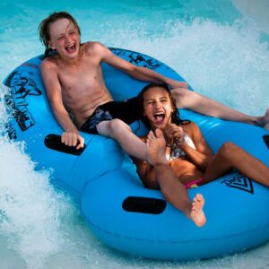 boy and girl in a double tube going down a waterslide