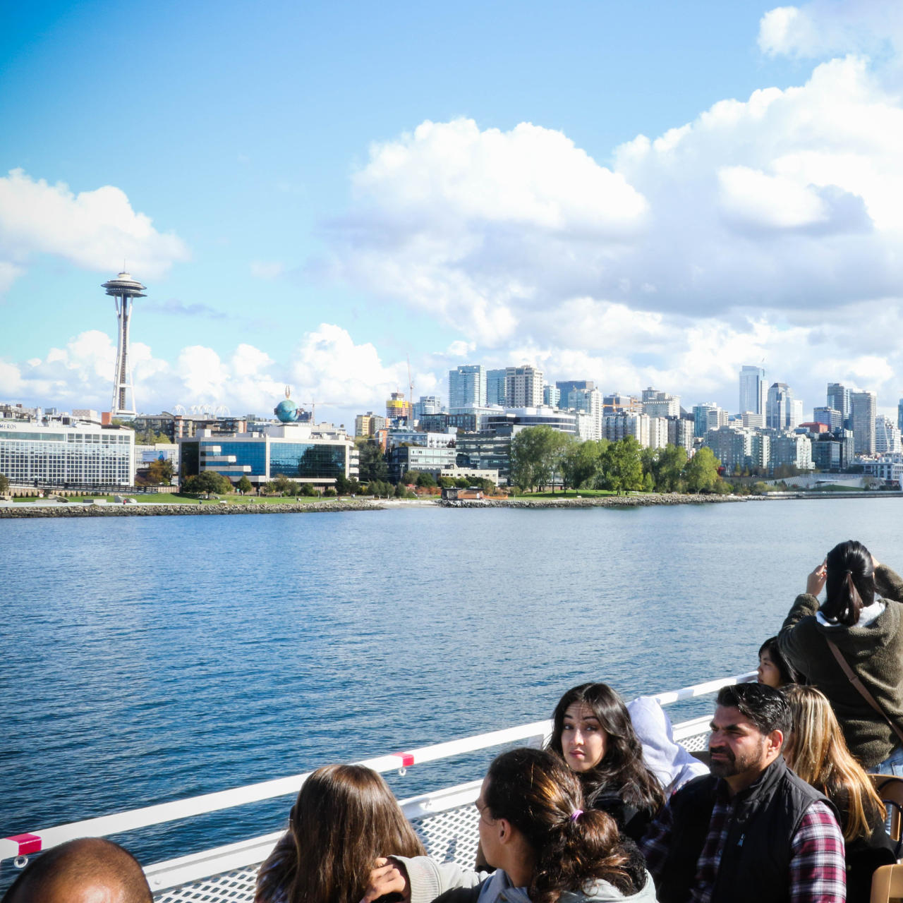 Hidden Gems from Seattle Premier Attractions - People aboard Argosy Cruises looking over the water at the Seattle skyline